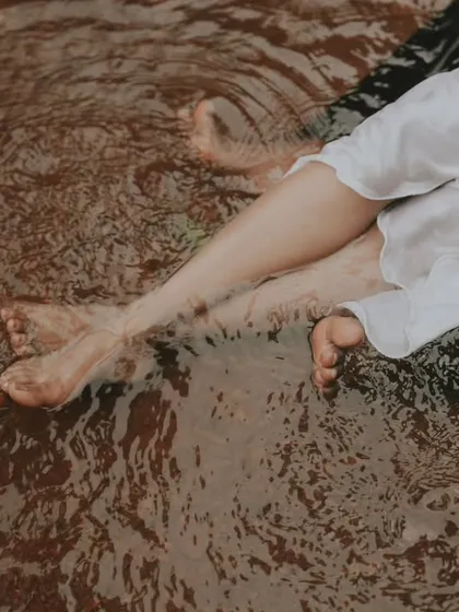 An abstract and artistic shot of a couple's feet in the rippling water. I love finding these unique perspectives during a creative couple session.