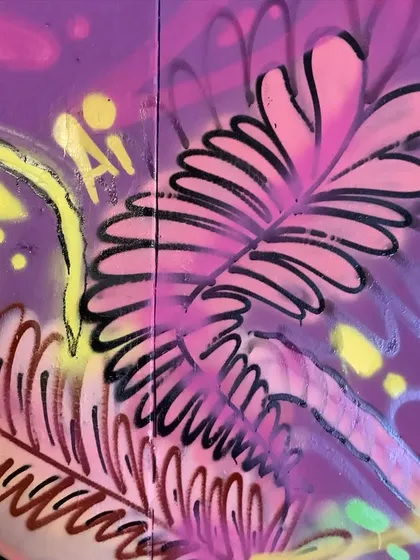 Detail of the pink and purple fern-like shapes from the floral piece.