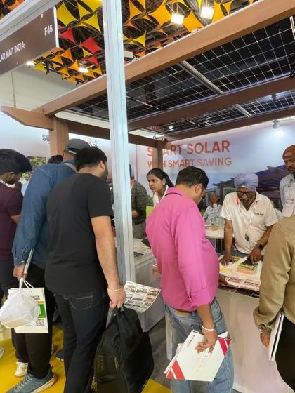 A crowd gathers at our HomeScape booth during an expo. The public's interest and insightful questions demonstrate a growing awareness and demand for residential solar power.