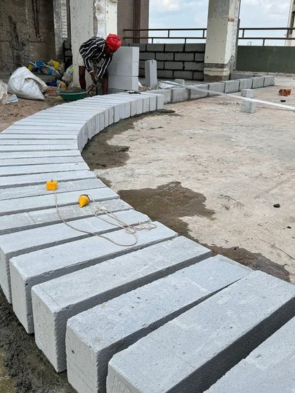 Laying out a curved wall with precision. Even complex architectural forms are executed with care and accuracy by my skilled build team.