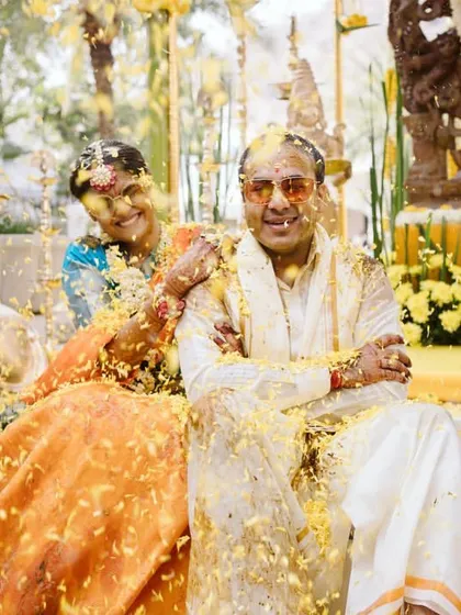 A playful flower shower for the couple during their Haldi. These moments of spontaneous joy are what make a wedding unforgettable.