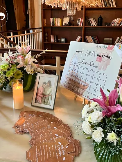 The interactive guest table for the jungle themed shower, featuring a "Guess Lil P's Birthday" calendar, personal photos, and custom designed advice cards.
