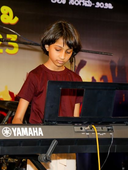 A young keyboardist performing on stage, a perfect example of how we sprout creativity in our students.