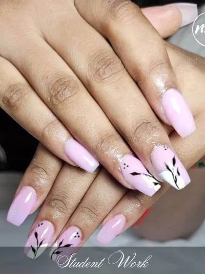 A beautiful soft pink set with a delicate leaf accent nail, created by one of our students. This showcases their ability to create elegant and wearable art.