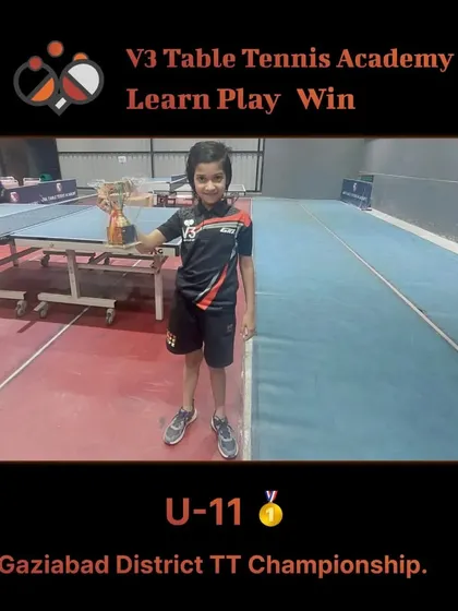 The U-11 Ghaziabad District champion proudly holding her trophy at the academy. Victories like these are what we strive for.