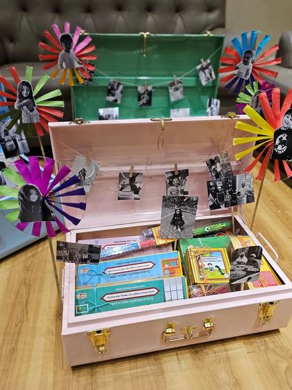 A closer look at the nostalgic kids' trunks. The combination of pastel colors, personal photos clipped to a string, and handmade pinwheels really uplifts the whole look.