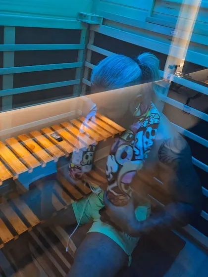 A moment of quiet reflection inside the sauna. The gentle, dry heat allows for longer, more meditative sessions where you can truly disconnect and focus on your well-being.