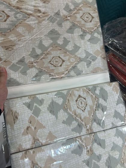 A modern ikat-inspired geometric pattern in earthy tones of beige and grey. This design offers a contemporary alternative while still providing the premium softness of Indian cotton.