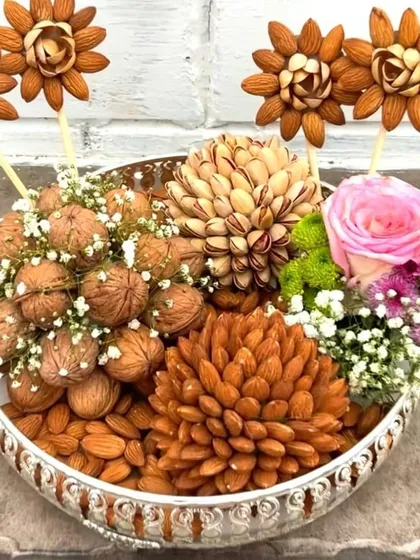 I love transforming simple gifts into works of art. This dry fruit platter is meticulously arranged with almonds, walnuts, and pistachios to resemble blooming flowers, making it a healthy and stunning gift for any occasion.
