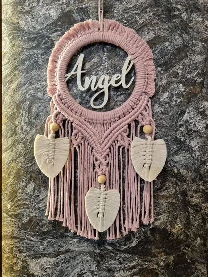We believe decor should be personal. This custom macrame name hanging, featuring the name 'Angel', is a perfect example of how we add a personal touch to your space, making it a treasured piece for a nursery, kid's room, or home office.