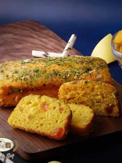 The Mango Bar Cake is a moist and flavorful tea cake infused with mango puree and chunks of real mango, perfect for an afternoon snack.