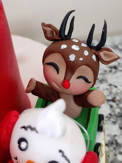 A sleepy little reindeer with a red nose, one of my favorite figurines from the Christmas cake.