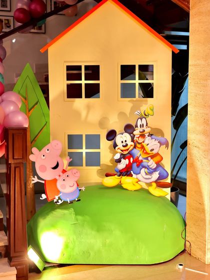 A detailed view of the Peppa Pig house prop, with character cutouts from both Peppa Pig and the Mickey Mouse Clubhouse, creating a unique and fun mashup theme.
