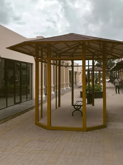 A shot of our shaded gazebo seating area, a quiet place for travelers to sit and relax amidst the open-air walkways of our campus.