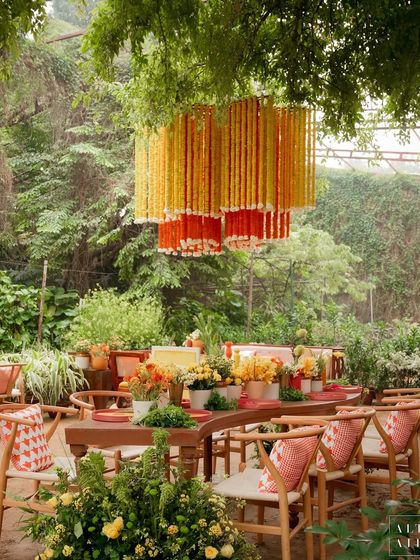 A dining table at the 'Kesar Sehar' Haldi, with a marigold chandelier overhead. This event was an ode to what Indian elements can transform into, blending tradition with a contemporary touch.