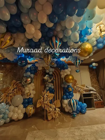 An immersive hot air balloon themed party. We covered the entire ceiling with blue and white balloons to look like the sky, and hung hot air balloon props and balloon garlands to complete the magical effect.