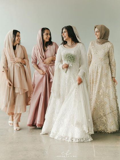 A beautiful portrait of the bride, Shifa, with her bridesmaids, all dressed in elegant, coordinated outfits for her Nikkah ceremony. Their smiles and camaraderie are heartwarming.