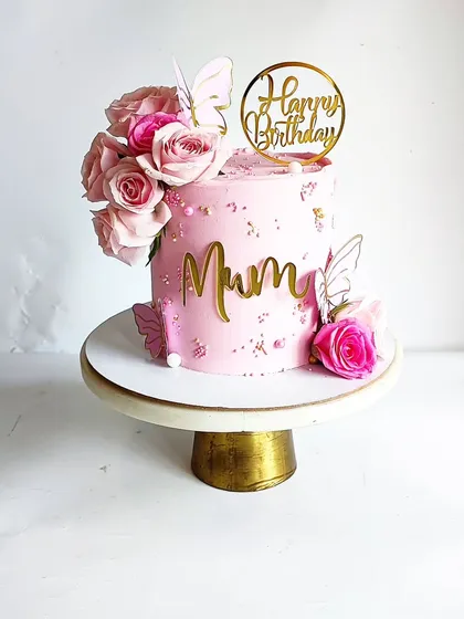 A special cake for a mother-in-law from her lovely daughter-in-law. This pink floral and butterfly cake is a beautiful way to celebrate family bonds.