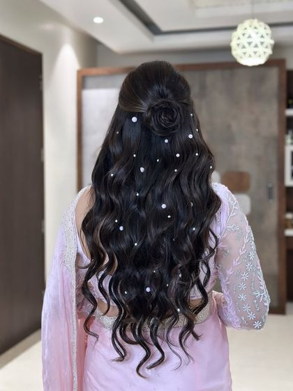 A beautiful half-up style with a rose bun and scattered pearls. This hairstyle is dreamy, romantic, and perfect for a soft, feminine look.