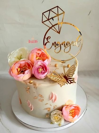 This gorgeous single-tier floral cake was for Jaisheen's intimate roka ceremony. Decorated with pink peonies, a golden butterfly, and a custom "Engaged" topper, this no-fondant cake was the perfect sweet start to their wedding journey.