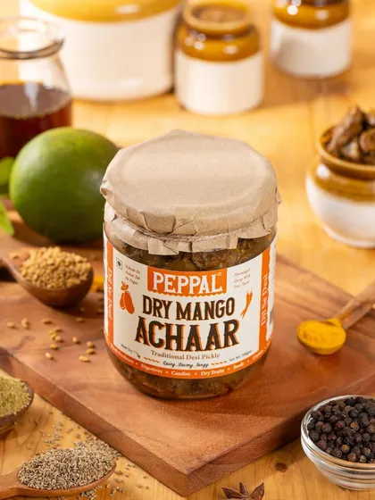 A product shot of Peppal's Dry Mango Achaar, with a focus on the ingredients used in the pickling process. This visual storytelling is great for brands that value transparency.