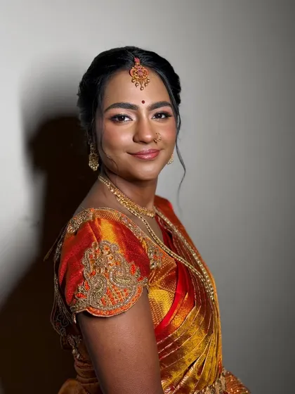 The joy of a bride on her special day is my greatest inspiration. For this traditional South Indian ceremony, I created a warm, glowing look with a dewy base and defined eyes to complement her vibrant Kanjeevaram saree and temple jewellery.