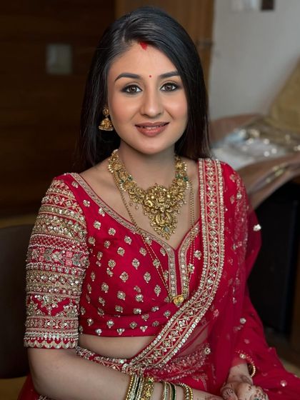 A close-up portrait highlighting the beautiful reception makeup. The skin is glowing, the eyes are softly smoked, and the lip color is a perfect nude.