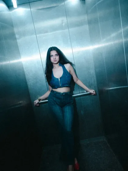A full-length shot from our elevator photoshoot, showing how the complete denim outfit works with the cool, metallic background. I help with posing to make you feel comfortable and confident in front of the camera.