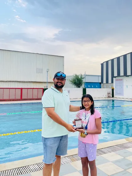 Presenting the 'Best Swimmer' trophy to Yuvika Sharma after she won 5 gold medals at an Inter-School swimming meet. My program is designed to create dominant swimmers at every level.