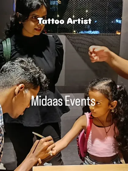 A tattoo artist carefully paints a design for a young guest. This activity provides a great photo opportunity and gives the kids a fun, temporary souvenir to remember the party by.