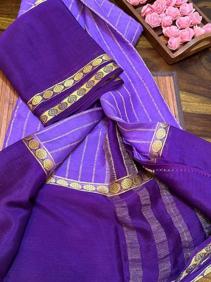 A beautiful purple wrinkle crepe Mysore silk saree with a matching blouse piece.