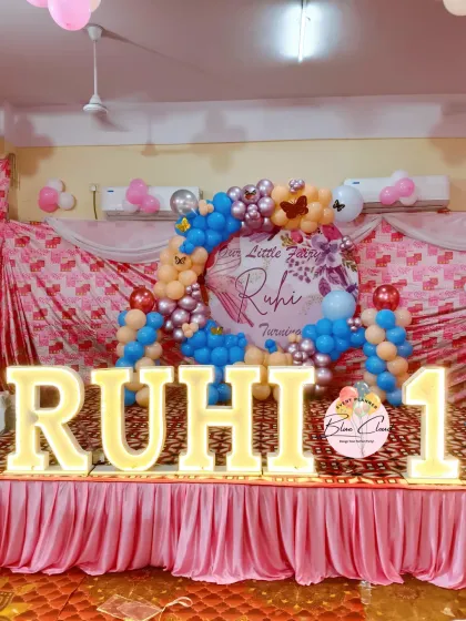 A "Little Fairy" themed first birthday with a custom backdrop and marquee letters. We used blue, pink, and chrome balloons to create this unique color combination.