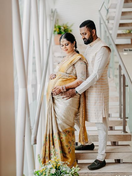 My husband and I on the stairs, sharing a quiet moment. The soft light highlights the beautiful texture of my silk saree and his custom-made vest.