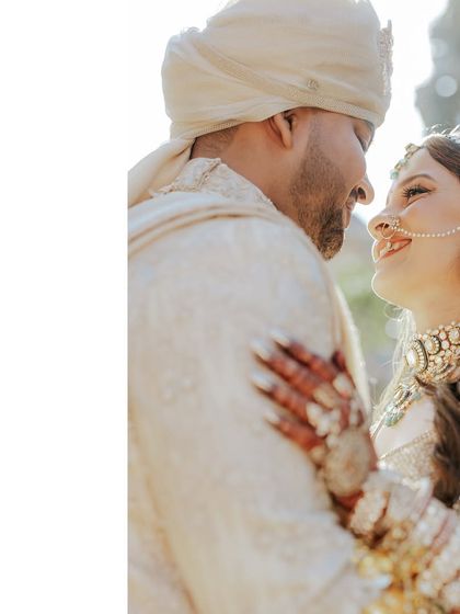 A close-up filled with love and happiness. You can see the beautiful detail in the bride's matha patti and nose ring, which were selected to harmonize with the groom's stately turban and attire.