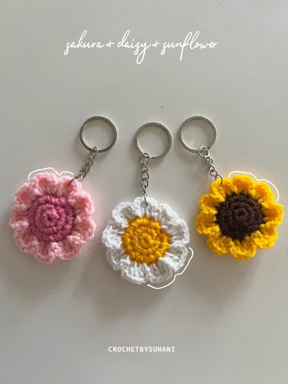 A vibrant set of my most popular flower keychains: a pink sakura, a classic white and yellow daisy, and a sunny sunflower. These add a pop of color to anything.