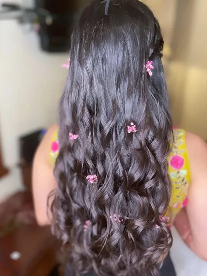 The back view of the Haldi hairstyle, showing the scattered flowers.