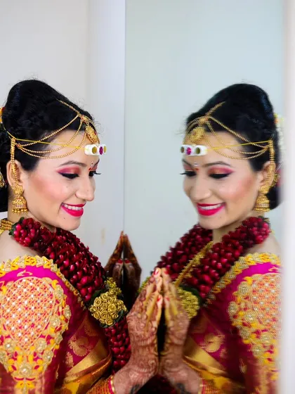 A radiant bride looking at her reflection. This shot captures her happiness and the perfection of her bridal makeup and hair.