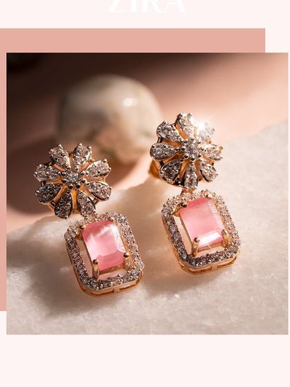 A closer view of our pink gemstone and diamond earrings. The floral diamond stud drops down to a rectangular pink stone, combining classic motifs with a modern silhouette.