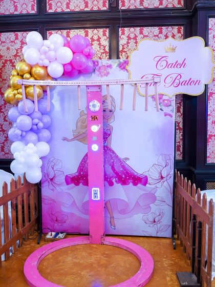 The "Catch the Baton" game, set against a glamorous Barbie backdrop, is another one of our custom-themed interactive stalls.
