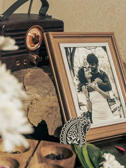 A beautiful heritage-themed corner with a vintage radio, a framed photo, and traditional wooden game board.