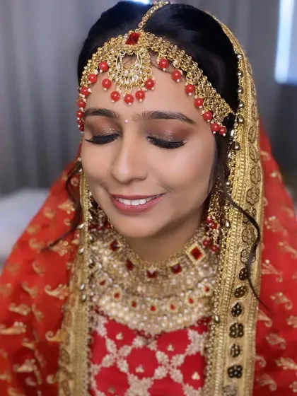 A close-up of the bridal makeup for this Punjabi ceremony. The focus is on the eyes, with a soft, shimmery look that enhances her natural beauty.