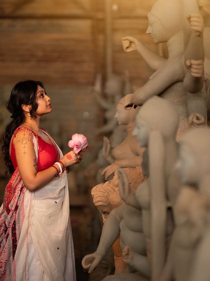 Another frame from the artistic Durga Puja series. The makeup is kept elegant and understated to fit the serene, creative atmosphere of the idol-making workshop, focusing on clean skin and expressive eyes.