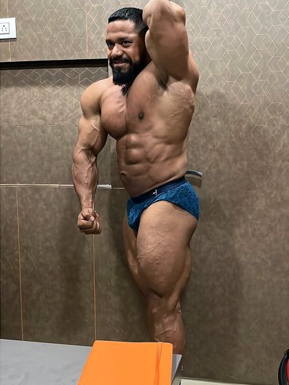 Side chest and bicep pose. This highlights the thickness of the chest and the peak of the bicep.