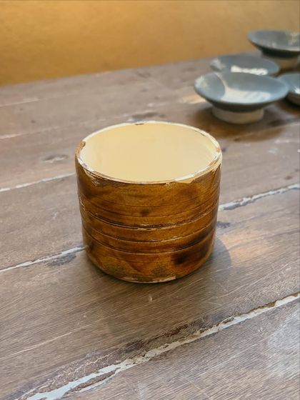 This student's quiet patience and steady curiosity shine through in these beautiful pieces from her beginner's course. The whimsical koi pond platter is a favorite, full of texture and calm joy.