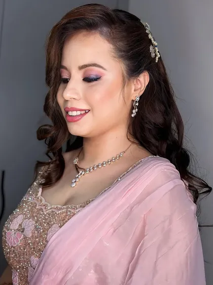This three-quarter view shows how the hairstyle frames the face beautifully. The side-swept curls and the delicate hair clip add a touch of romance to the overall look.