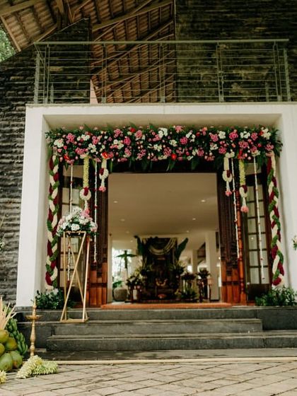 The entrance to a beautiful morning wedding, with traditional floral torans and banana plants creating a welcoming and auspicious vibe.