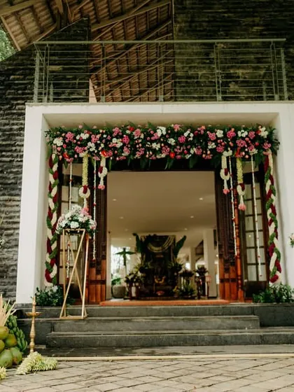 The entrance to a traditional South Indian wedding, decorated with floral garlands and banana saplings, which are symbols of prosperity and welcome.