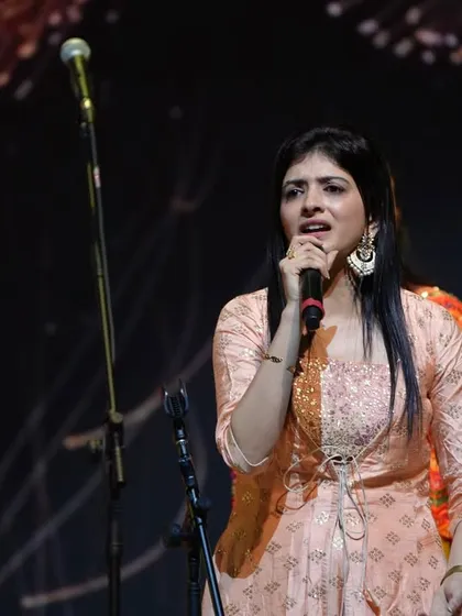 Our co-founder Vishala singing on stage during a performance at SRMD Dharampur.