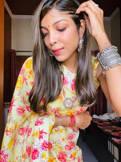 A close-up showing how I paired the floral saree with oxidized silver bangles and earrings. The right accessories can completely elevate a simple outfit.