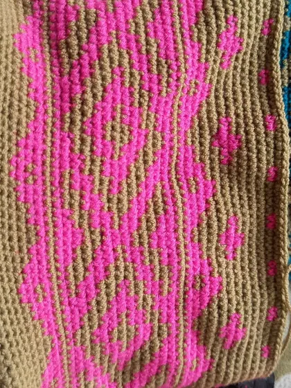 The main panel of the tapestry backpack laid flat, displaying the full intricacy of the pattern before it's assembled.